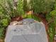 Aerial view showcases home's layout including back deck, screened in room and grassy lawn surrounded by landscaping at 108 Vescova Ln, Morrisville, NC 27560