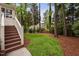 Backyard landscaping with a well-manicured lawn and beautiful trees at 108 Vescova Ln, Morrisville, NC 27560