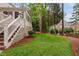 Landscaped backyard with lush green lawn and surrounding trees at 108 Vescova Ln, Morrisville, NC 27560