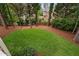 View of the manicured backyard featuring a well-maintained lawn and lush landscaping at 108 Vescova Ln, Morrisville, NC 27560