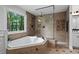 Bright bathroom featuring a soaking tub and a glass shower at 108 Vescova Ln, Morrisville, NC 27560