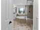 Bright bathroom featuring a soaking tub, glass shower, and a large window providing natural light at 108 Vescova Ln, Morrisville, NC 27560