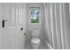 Bathroom featuring toilet, tub, and a window view to the outside at 108 Vescova Ln, Morrisville, NC 27560