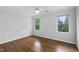 Bedroom with hardwood floors, a ceiling fan, and two windows at 108 Vescova Ln, Morrisville, NC 27560
