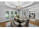 Bright dining room features a modern chandelier, white trim, and shuttered windows for natural light at 108 Vescova Ln, Morrisville, NC 27560