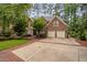 Charming brick home with a two-car garage, beautiful landscaping, and a brick walkway and driveway at 108 Vescova Ln, Morrisville, NC 27560