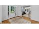Bright foyer with hardwood floors, a glass-paneled front door, and an open view into the office at 108 Vescova Ln, Morrisville, NC 27560
