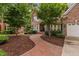 Beautiful brick home with mature landscaping and a brick walkway at 108 Vescova Ln, Morrisville, NC 27560