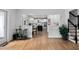 View of a hallway with hardwood floors connecting the kitchen and stairs to upper levels at 108 Vescova Ln, Morrisville, NC 27560
