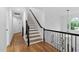 Hallway featuring hardwood floors and a staircase with iron railing at 108 Vescova Ln, Morrisville, NC 27560
