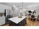 Kitchen with stainless steel appliances, a kitchen island, and a view into living areas at 108 Vescova Ln, Morrisville, NC 27560