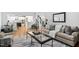 Cozy living room with hardwood floors, comfortable seating, and open view to the kitchen and staircase at 108 Vescova Ln, Morrisville, NC 27560