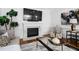 Bright living room with fireplace and large TV, stylish furniture and decor, and hardwood floors at 108 Vescova Ln, Morrisville, NC 27560