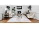 Bright living room with fireplace, large TV, stylish furniture and decor, and hardwood floors at 108 Vescova Ln, Morrisville, NC 27560