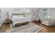 Bright main bedroom with neutral tones, wood floors, and sitting area at 108 Vescova Ln, Morrisville, NC 27560