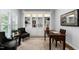 Cozy office features custom built-in shelving with decorative items, a desk, and comfortable seating at 108 Vescova Ln, Morrisville, NC 27560
