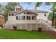 Expansive home rear featuring a lattice-enclosed porch and lush green lawn at 108 Vescova Ln, Morrisville, NC 27560