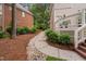 Inviting side yard featuring a stone path and manicured landscaping at 108 Vescova Ln, Morrisville, NC 27560