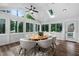 Bright sunroom with vaulted ceilings, skylight, and large windows showcasing wooded outdoor views at 108 Vescova Ln, Morrisville, NC 27560