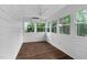 Cozy sunroom with wood paneled walls and windows with wooded views at 108 Vescova Ln, Morrisville, NC 27560
