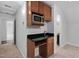 Wet bar featuring granite counter tops and stainless steel microwave at 108 Vescova Ln, Morrisville, NC 27560