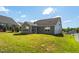 Backyard view of a single Gathering home with a well maintained lawn at 1085 Lobdale Ct, Burlington, NC 27215