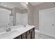 Bathroom featuring dual sinks and a shower behind glass doors at 1085 Lobdale Ct, Burlington, NC 27215