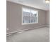 Bright bedroom featuring neutral walls, carpet floors, and a large window at 1085 Lobdale Ct, Burlington, NC 27215