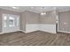 Bright dining room with elegant wainscoting, hardwood floors, and a view of the front door at 1085 Lobdale Ct, Burlington, NC 27215