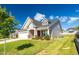 Charming two-story home with manicured lawn, neutral siding, and a welcoming two-car garage at 1085 Lobdale Ct, Burlington, NC 27215