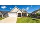 Inviting front exterior with a well-maintained lawn and a two-car garage and neutral colors at 1085 Lobdale Ct, Burlington, NC 27215