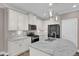 Close-up of the kitchen with granite countertops, island, and stainless steel appliances and pendant lighting at 1085 Lobdale Ct, Burlington, NC 27215