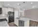 Bright kitchen features a large island with granite countertops and stainless steel appliances at 1085 Lobdale Ct, Burlington, NC 27215