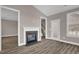 Living room with fireplace and a back door with access to a staircase at 1085 Lobdale Ct, Burlington, NC 27215