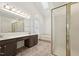 Bright bathroom with a double vanity, a tub, a walk-in shower with a partially frosted glass door at 111 Catherwood Pl, Cary, NC 27518