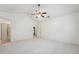 Spacious primary bedroom offers a ceiling fan, neutral carpeting, and en suite bath at 111 Catherwood Pl, Cary, NC 27518