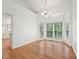 Bright dining room with hardwood floors and large windows overlooking the backyard at 111 Catherwood Pl, Cary, NC 27518