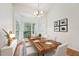 Bright dining room features a chandelier, light walls, hardwood flooring, and a bay window at 111 Catherwood Pl, Cary, NC 27518