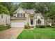 Charming two-story home featuring a well-manicured lawn and attached two car garage at 111 Catherwood Pl, Cary, NC 27518