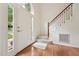 Bright foyer with hardwood floors, staircase, and large window beside the front door at 111 Catherwood Pl, Cary, NC 27518