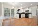Kitchen with a dining nook, black appliances, white cabinets, and an adjacent outdoor patio at 111 Catherwood Pl, Cary, NC 27518