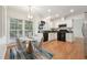 Charming kitchen features white cabinets, black appliances, and a breakfast nook with large windows at 111 Catherwood Pl, Cary, NC 27518