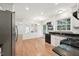 Open concept kitchen features stainless steel appliances, granite counters, and views to dining area at 111 Catherwood Pl, Cary, NC 27518