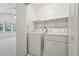 Bright laundry room features appliances and shelving at 111 Catherwood Pl, Cary, NC 27518