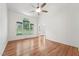 Spacious living room with hardwood floors, a ceiling fan, and large windows for plenty of natural light at 111 Catherwood Pl, Cary, NC 27518