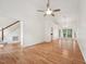 Open-concept living room with hardwood floors, stairs, and a view into the adjacent dining area at 111 Catherwood Pl, Cary, NC 27518