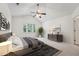 Cozy main bedroom with a ceiling fan, neutral carpet, and natural light coming in from a window at 111 Catherwood Pl, Cary, NC 27518