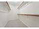 Walk-in closet offers ample built-in shelving, and neutral carpeting at 111 Catherwood Pl, Cary, NC 27518
