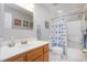 Bathroom with wood vanity, single sink, and tiled shower/tub at 1113 Pilton Pl, Raleigh, NC 27604