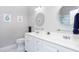 Bright bathroom featuring double sinks, white cabinets, and modern fixtures at 1113 Pilton Pl, Raleigh, NC 27604